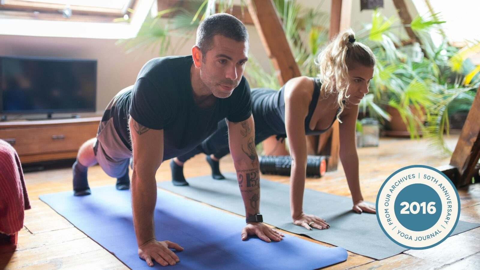 People in Plank pose on yoga mat.
