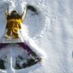 A woman making snow angels while fending off her holiday angst.