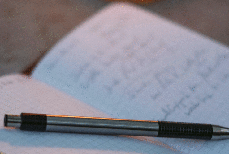 An open writing journal with a pen