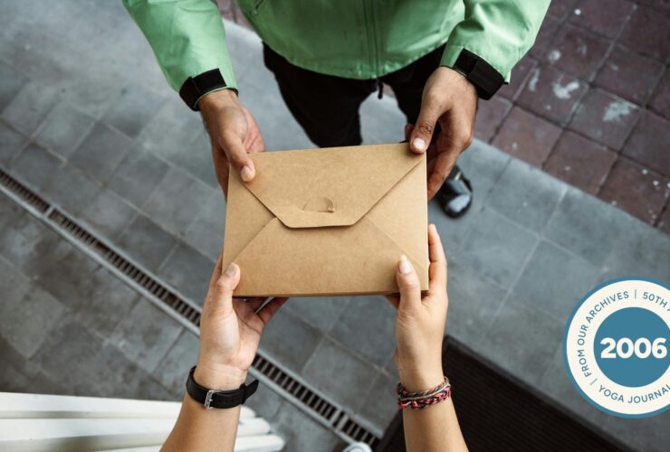 Close-up of two people exchanging cardboard box of food.