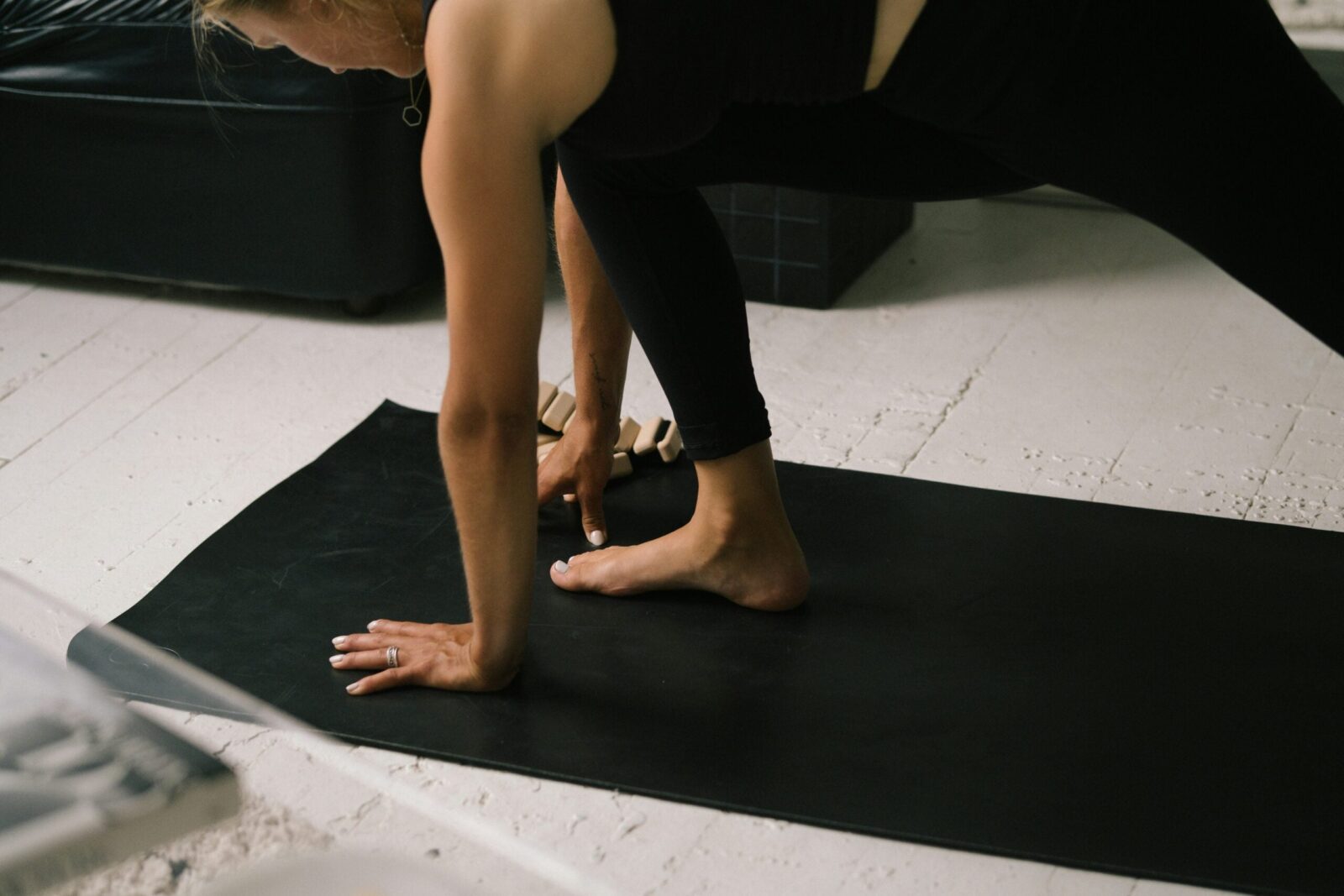 Image of woman on yoga mat practicing a lunge for hip flexors.