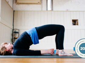Woman in Bridge Pose on yoga mat.