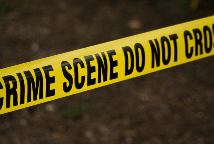 Bright yellow crime scene tape against a dark background as the setting for a murder mystery novel