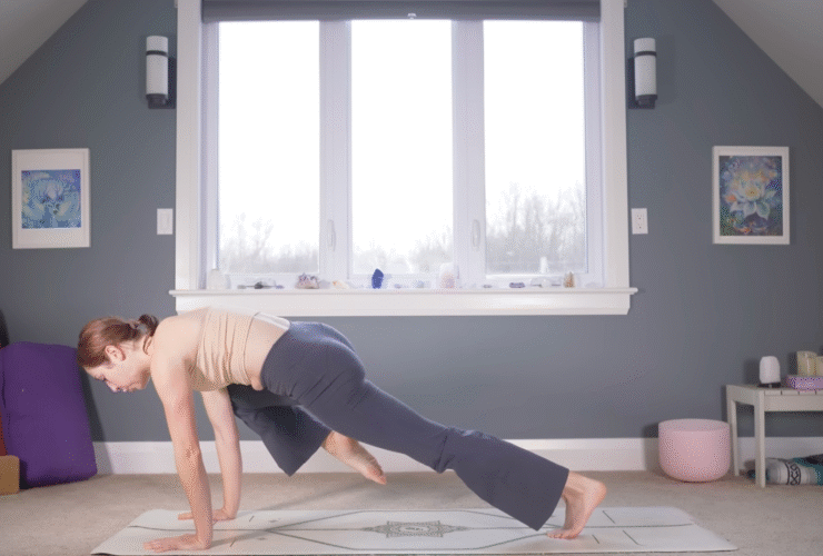 Woman in Plank Pose drawing one knee toward her nose during yoga for strength