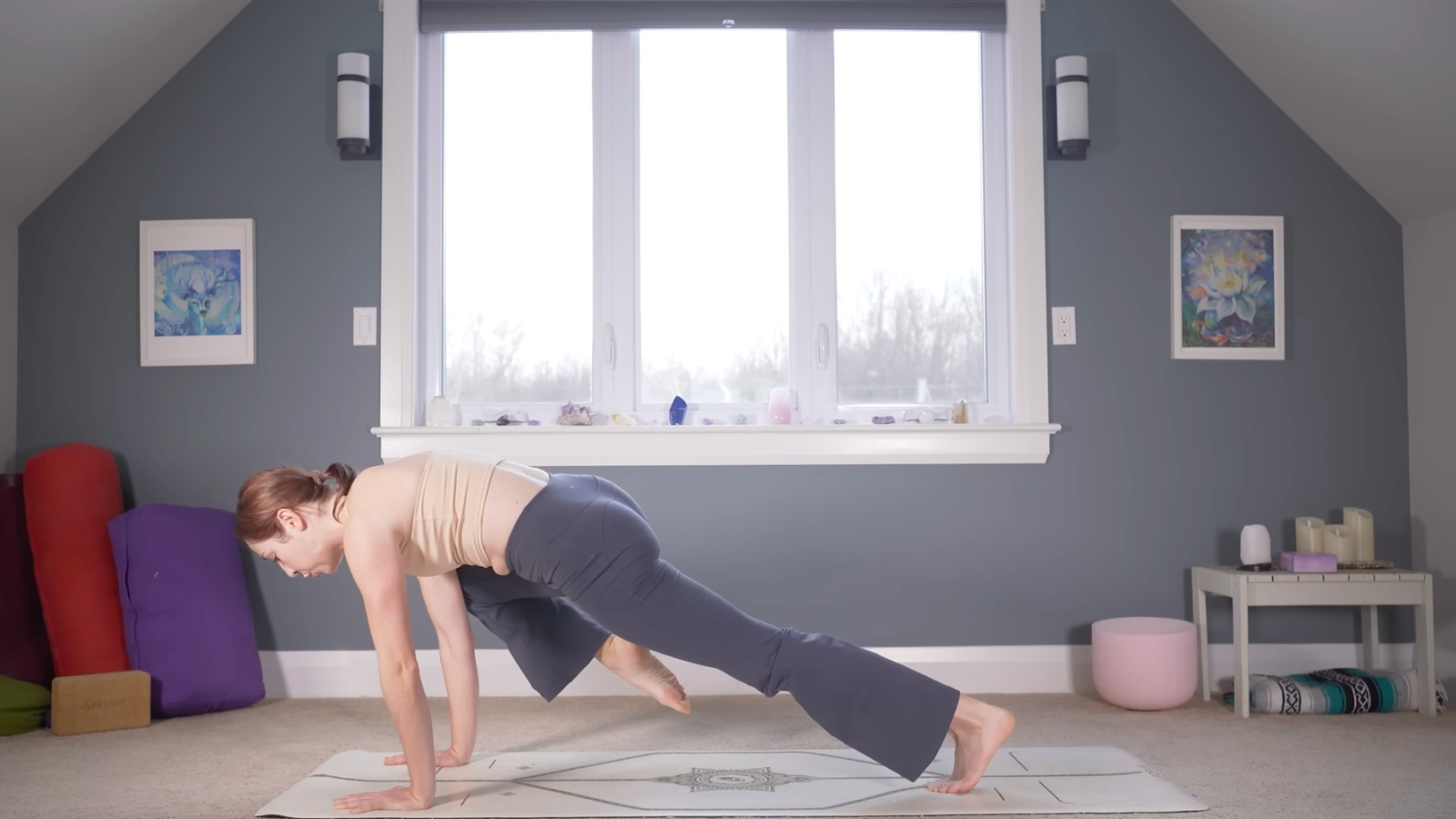 Woman in Plank Pose drawing one knee toward her nose during yoga for strength