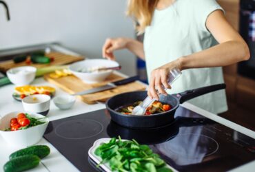woman cooking at home in kitchen healthy food