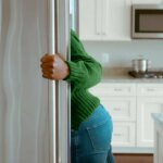 woman looking in the fridge for a snack