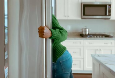 woman looking in the fridge for a snack