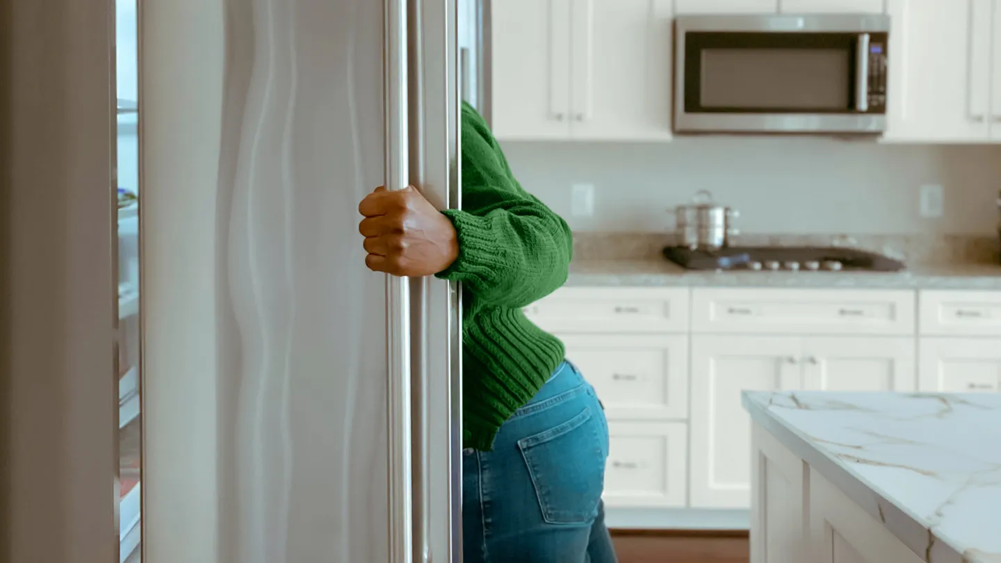 woman looking in the fridge for a snack