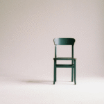 A wooden chair sitting against a wall in preparation for a chair yoga class