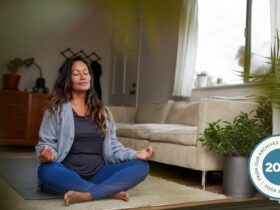 Woman sitting in Easy Pose with her hands in Gyan Mudra.