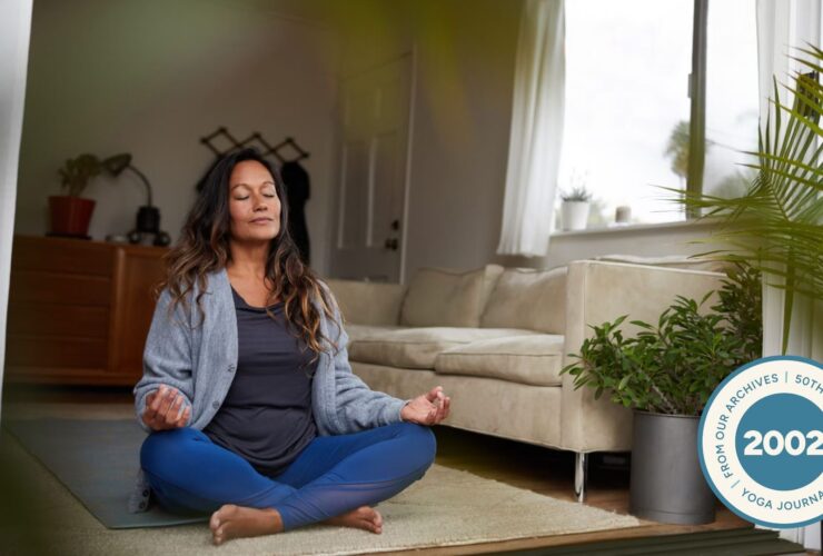 Woman sitting in Easy Pose with her hands in Gyan Mudra.