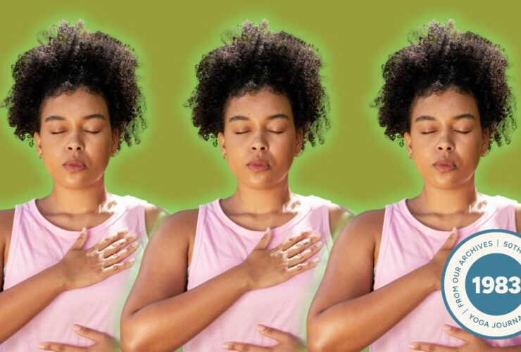 A woman taking deep breaths, part of a pranayama practice