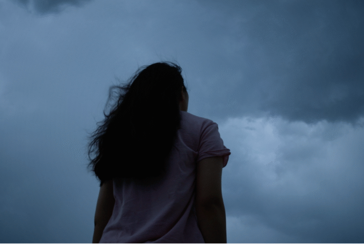 Woman standing outside beneath the new Moon in Capricorn thinking about her weekly horoscope