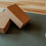 Image of a black yoga mat and cork blocks demonstrating the meaning of yoga