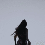 Silhouette of a woman outside during winter at dusk looking ahead and contemplating her weekly horoscope