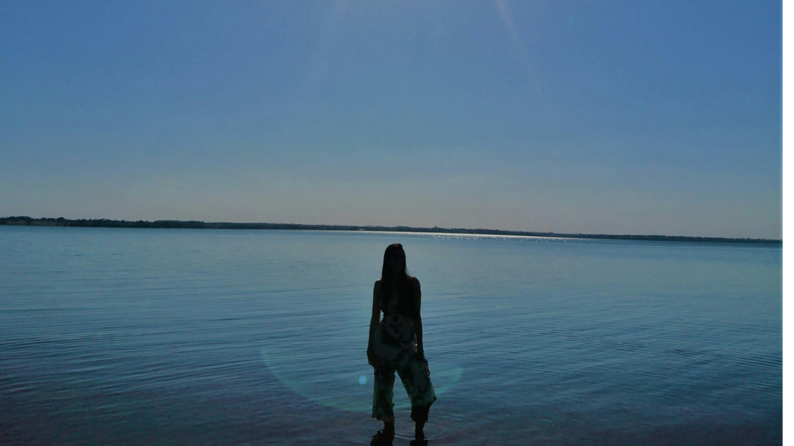 Woman's silhouette standing on the beach after sunset while thinking aout the weekly forecast january 4-10, 2026