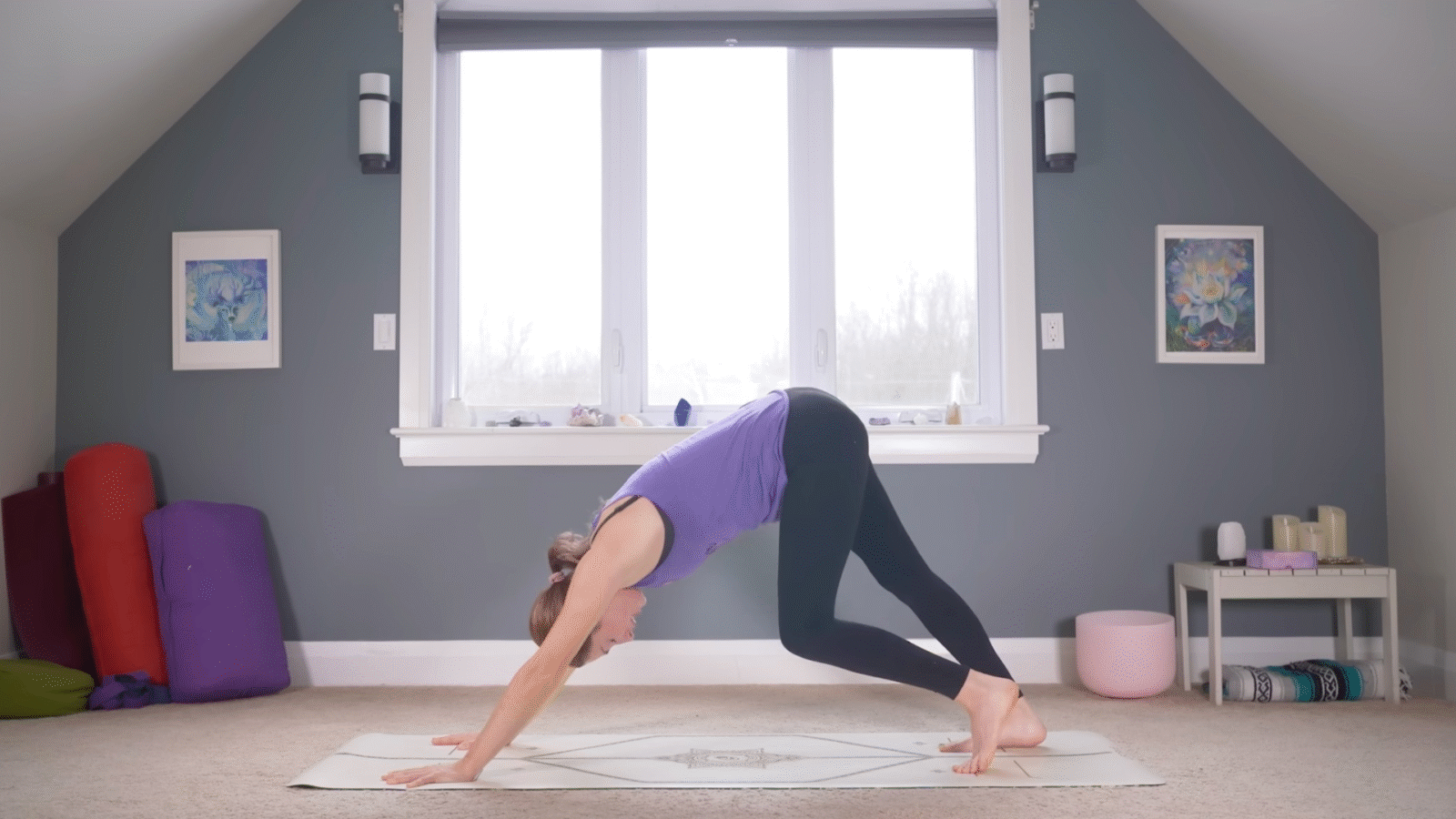 Woman in Downward-Facing Dog with one knee bent and the other straight