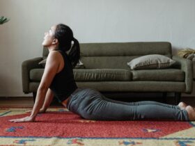 Woman practicing cobra pose at home