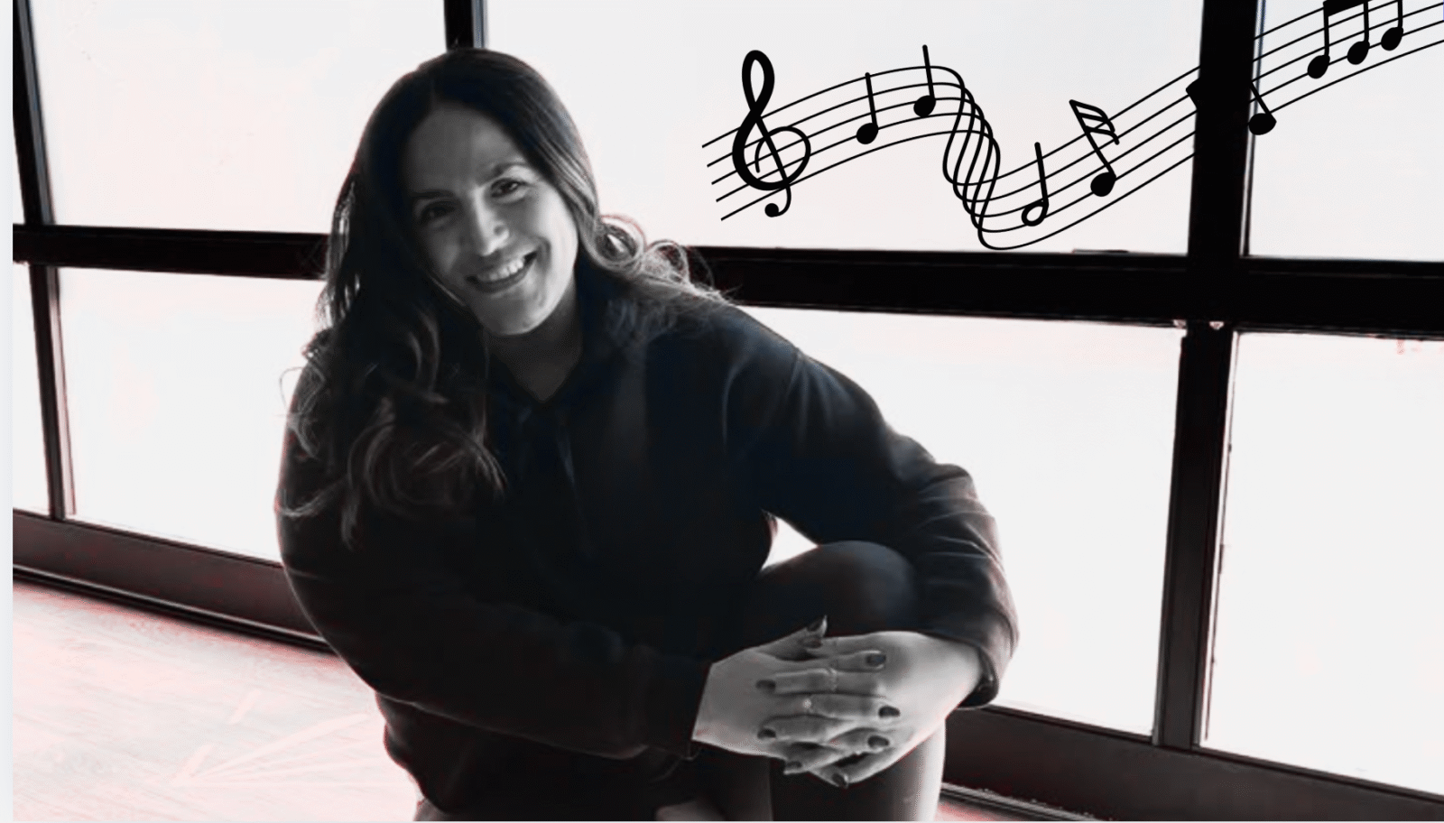 Yoga teacher Anaiz Ochoa sitting on the wood floor at Sweatshop Central yoga studio in Phoenix, where she teaches yoga with Bad Bunny playlists