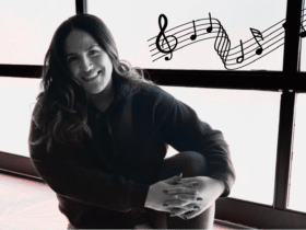 Yoga teacher Anaiz Ochoa sitting on the wood floor at Sweatshop Central yoga studio in Phoenix, where she teaches yoga with Bad Bunny playlists