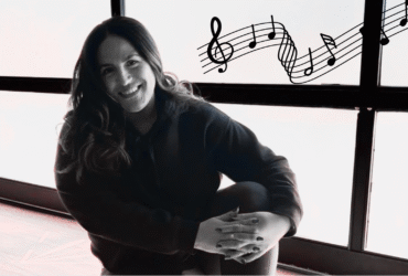 Yoga teacher Anaiz Ochoa sitting on the wood floor at Sweatshop Central yoga studio in Phoenix, where she teaches yoga with Bad Bunny playlists