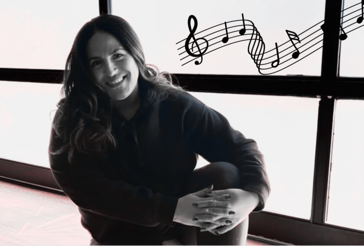 Yoga teacher Anaiz Ochoa sitting on the wood floor at Sweatshop Central yoga studio in Phoenix, where she teaches yoga with Bad Bunny playlists