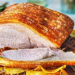 Pork loin roast with caramelised onion & garlic potatoes recipe