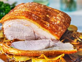 Pork loin roast with caramelised onion & garlic potatoes recipe