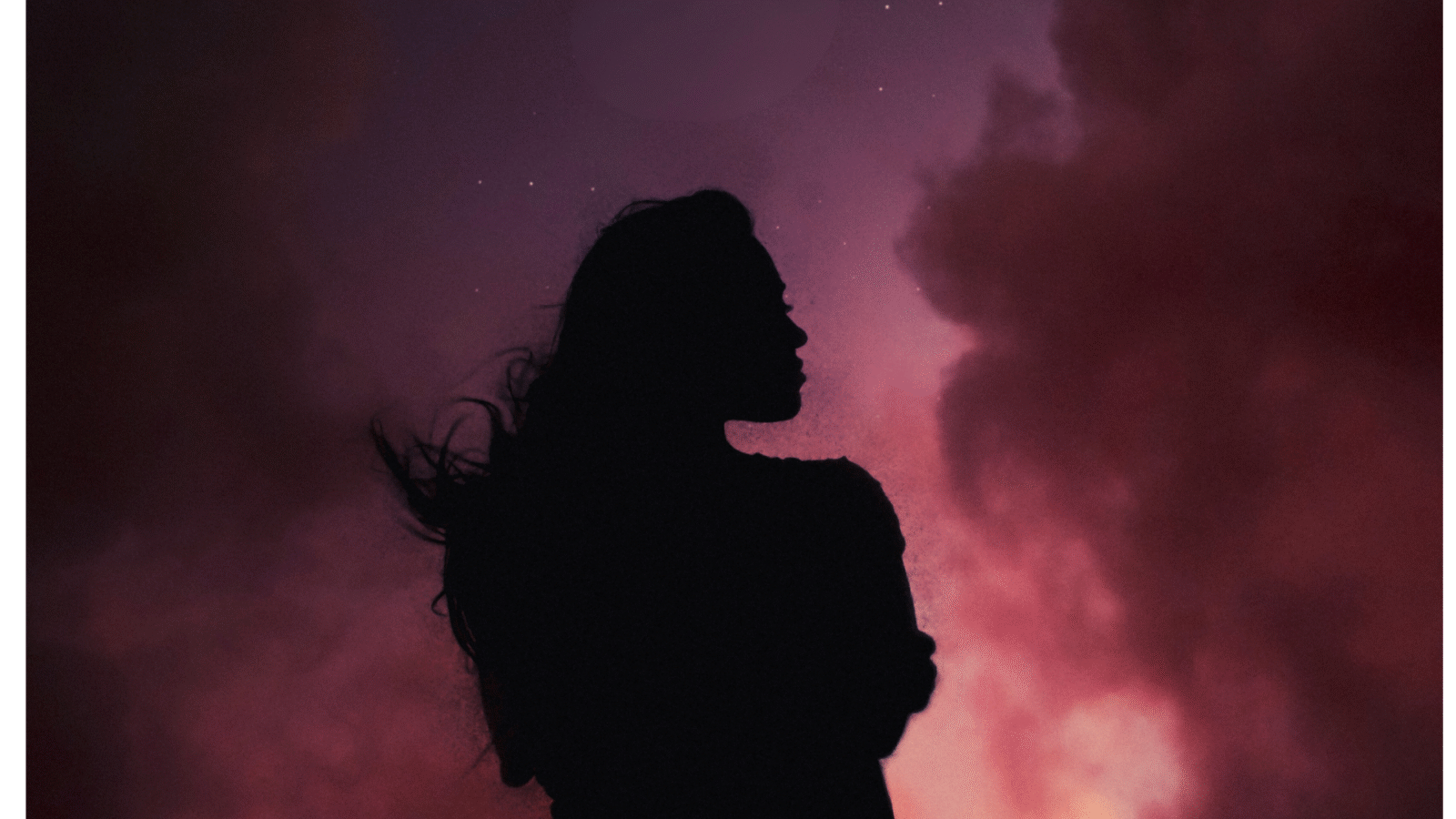 Woman silhouette in front of the blood red color of the total lunar eclipse