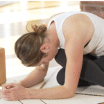 Woman practicing a forward bend that's a hip opener