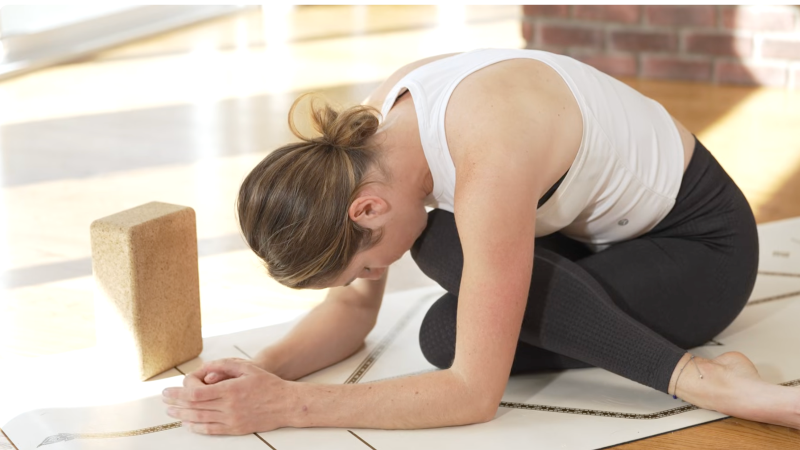 Woman practicing a forward bend that's a hip opener