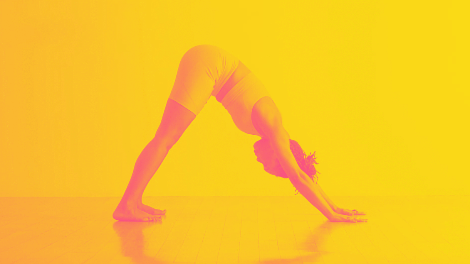 A woman in Downward-Facing Dog