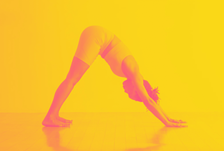 A woman in Downward-Facing Dog