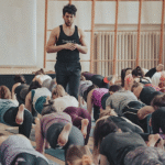 London-based yoga teacher Adam Husler teaches a class while walking and watching rather than demonstrating poses.