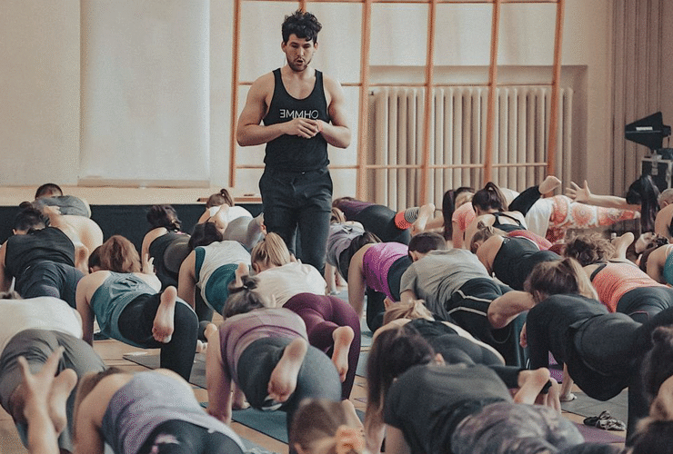 London-based yoga teacher Adam Husler teaches a class while walking and watching rather than demonstrating poses.
