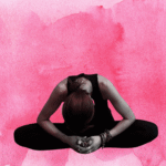 Woman sitting in a seated forward bend with a background of red.