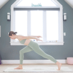 Woman in High Lunge leaning her chest forward and reaching her arms behind her