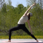 Woman standing on a mat in Reverse Warrior