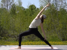 Woman standing on a mat in Reverse Warrior