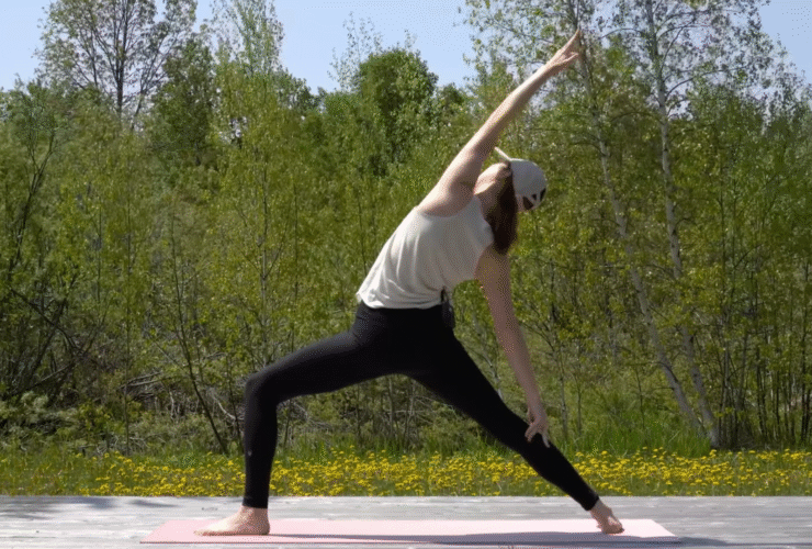 Woman standing on a mat in Reverse Warrior