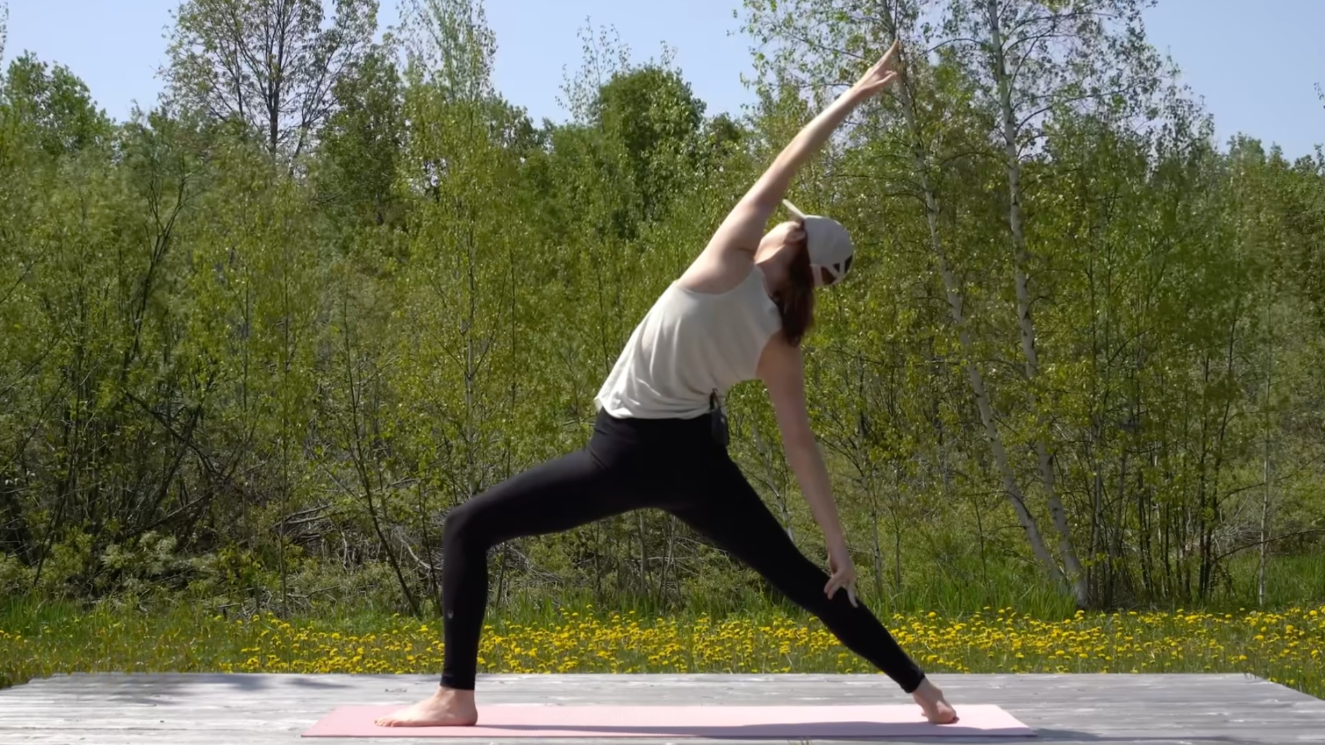 Woman standing on a mat in Reverse Warrior