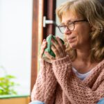 mature woman drinking herbal tea for menopause symptoms
