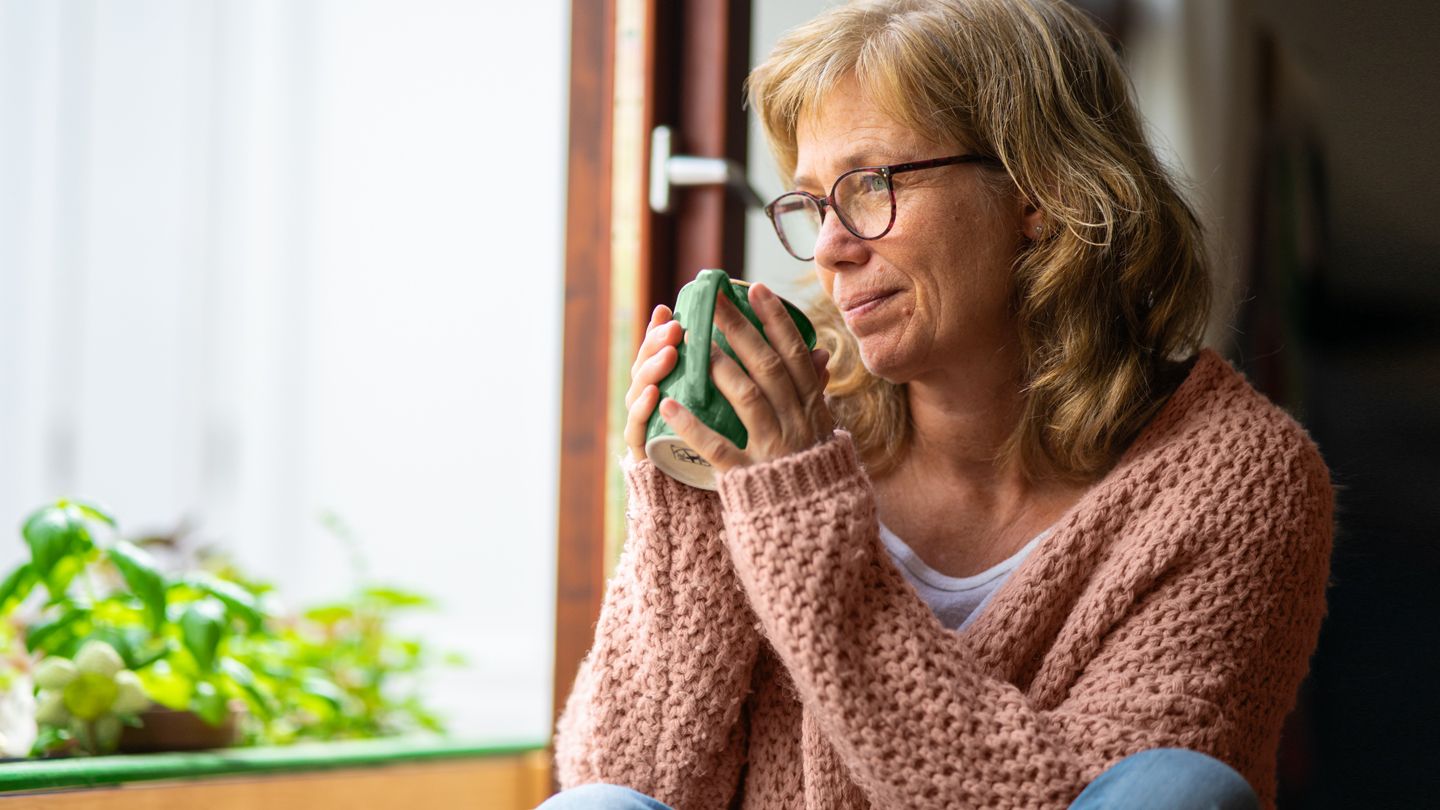 mature woman drinking herbal tea for menopause symptoms