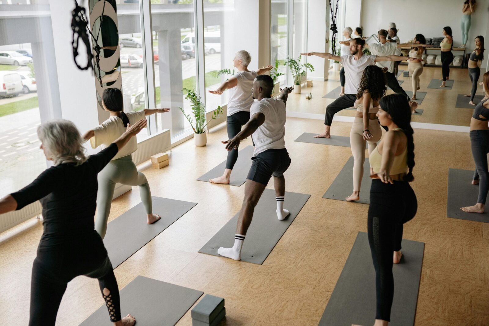 Image of yoga class practicing Warrior 2.