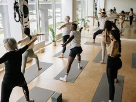Image of yoga class practicing Warrior 2.
