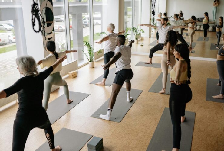 Image of yoga class practicing Warrior 2.