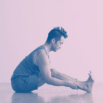 A man in Seated Forward Bend, a stretch for tight hamstrings