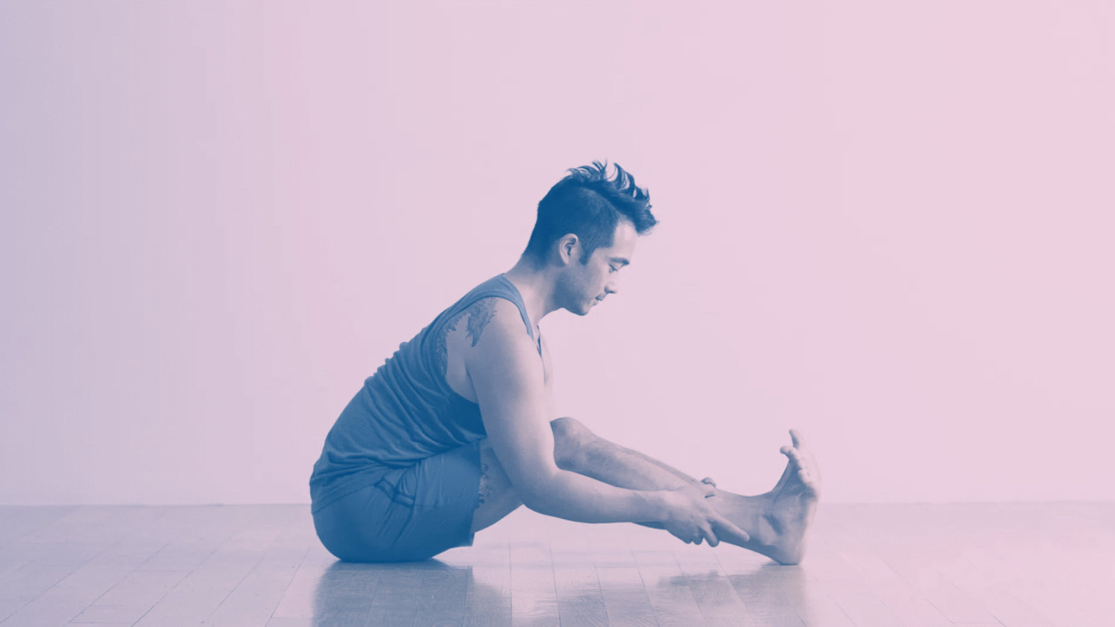 A man in Seated Forward Bend, a stretch for tight hamstrings