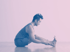 A man in Seated Forward Bend, a stretch for tight hamstrings